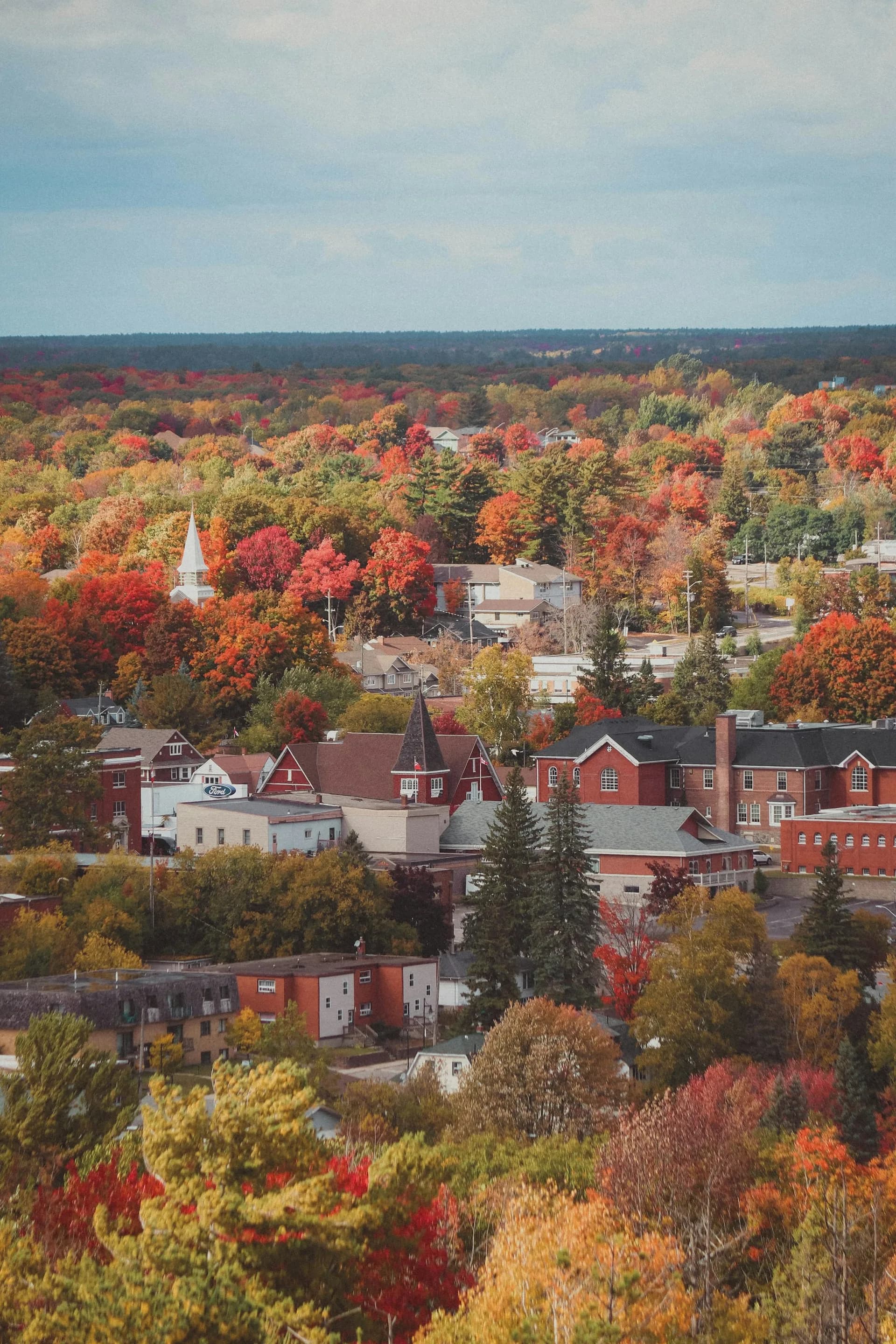 An aerial view of a New England town in autumn, representing central Connecticut.