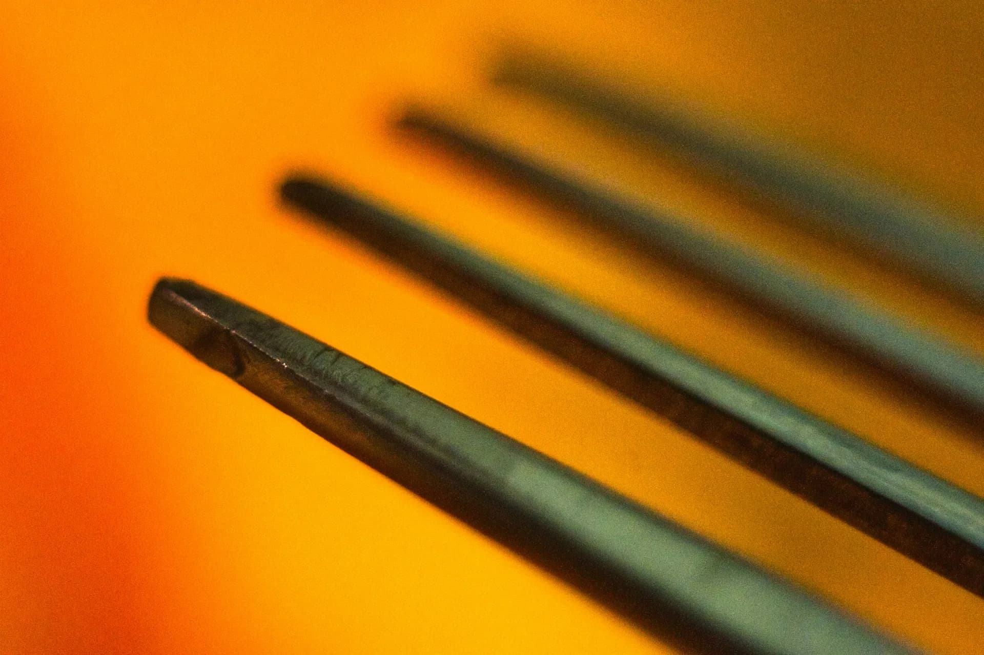 A close-up of acupuncture needles placed in a patient's back.