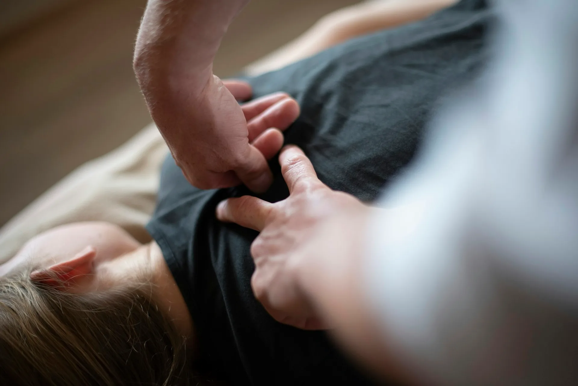 A chiropractor performing a spinal adjustment on a patient.