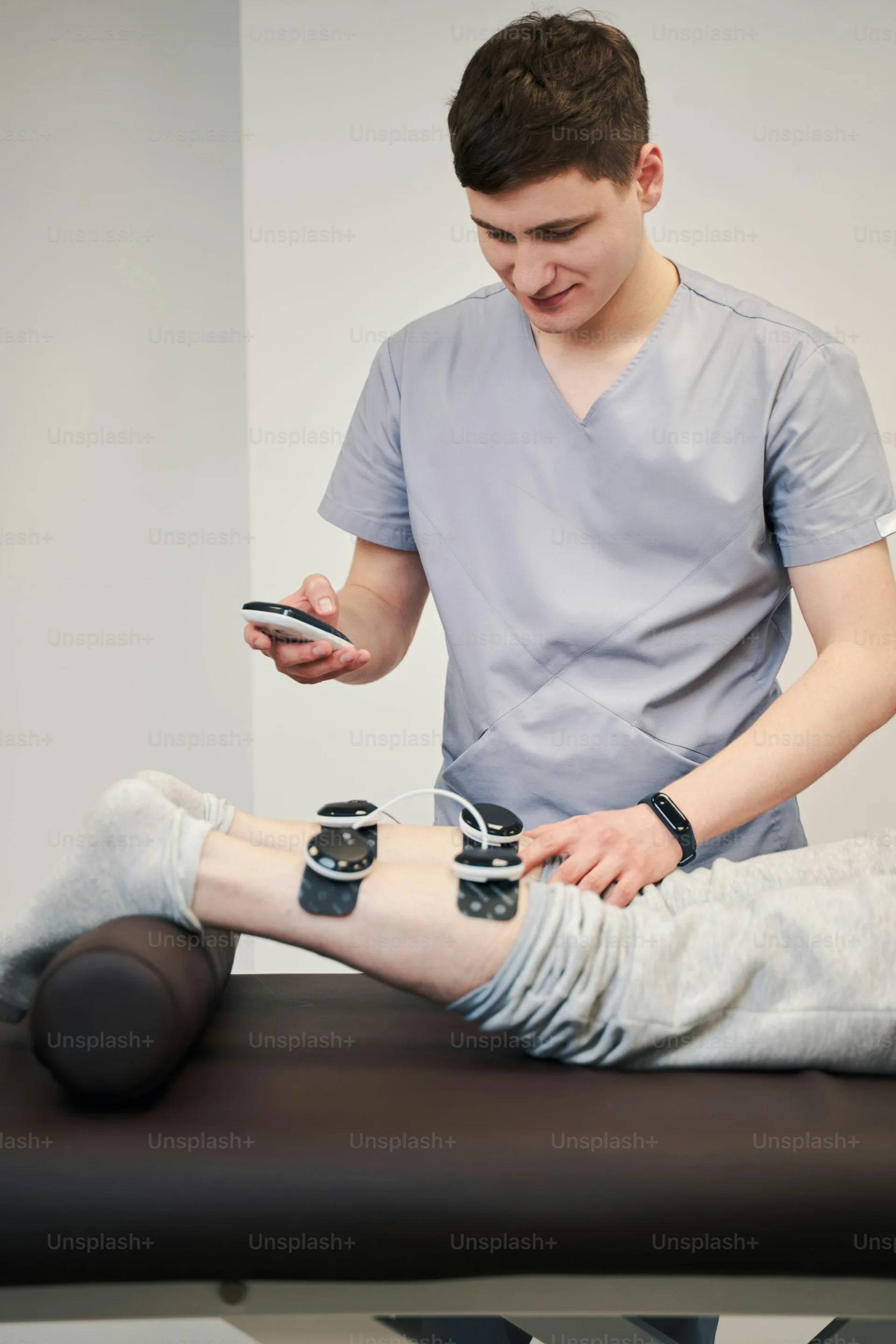 Electrical stimulation electrodes attached to a patient during therapy.