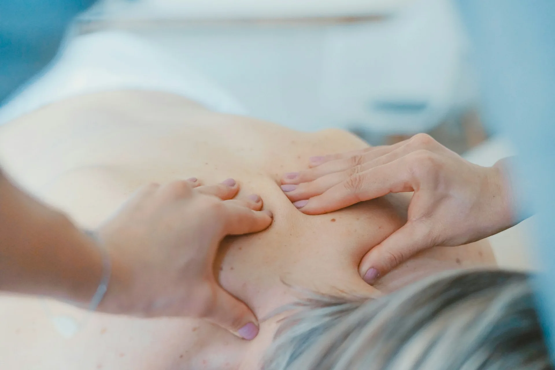 A massage therapist working on a patient's back.