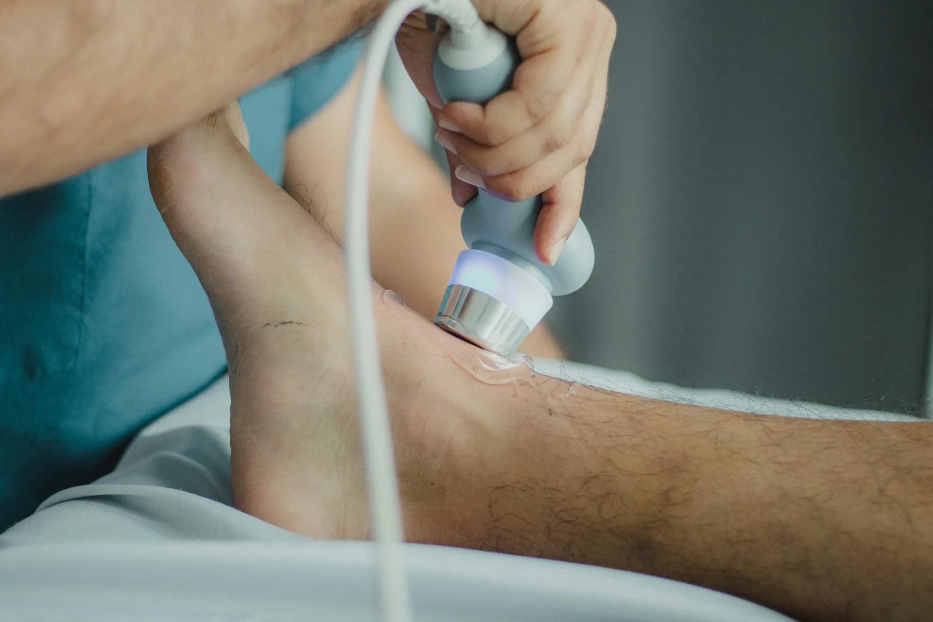 A therapeutic ultrasound wand being applied to a patient.